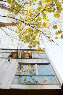 Hale and Maisie peer out of one of the living-room windows, from where Edmonds (pictured at left with Pippa) dreams about installing a zip-line directly to their garden patch.