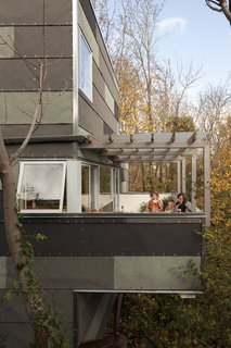 On the east-facing porch off of the kitchen, Edmonds rests for a minute with the twins. There's sometimes a swing hanging from the overhead beams but more often than not "it's a place for morning coffee," Hale says.