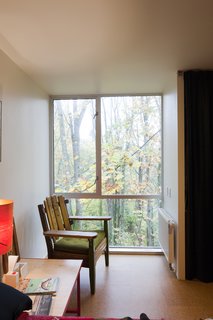 The bottom level features two equal-size bedrooms (shown here is Hale and Edmond's bedroom), a bathroom, and storage space. The family is always close to nature. One spring, Maisie and Pippa woke up each morning to a family of squirrels living in their nest outside the twin's bedroom window.