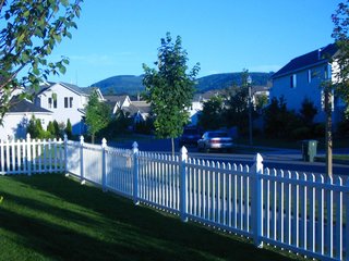 Building the Maxon House: Week 1 - Photo 3 of 10 - View from side yard. Corner lot, white picket fence, mountain view and streets lined with suburbia.