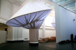 The marriage of columns and fabric came through independent studies of each. The fluting of Roman and Greek columns inspired, in part, the pleating of the fabric. The giant rings are also reflective of the early 18th century caged crinoline, or hoop skirt, a popular fashion at the time of the building’s original construction.