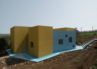 Everything About This Vacation Home in Israel is a Little Crazy - Photo 2 of 8 - The house sits on a slope, atop blue concrete and ceramic tiles. A set of web-shaped stairs (right) flow like a waterfall onto the blue floor.<br><br>Photo courtesy <br><br>Z-A Studio.
