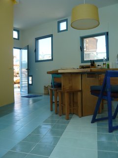 Everything About This Vacation Home in Israel is a Little Crazy - Photo 3 of 8 - The area between the blocks is public space, with walls much more perforated there to provide lightness for the vacation home. Gradient shades of blue ceramic tiles relate to the blue walls and tiles outside.<br><br>Photo courtesy <br><br>Z-A Studio.