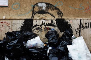 Friday Finds 3.18.11 - Photo 1 of 5 - Photojournalist Finbarr O'Reilly documented anti-Qaddafi sentiments strewn across walls and on posters in Libya. Photo via Caricaturing-qaddafi">The New York Times.