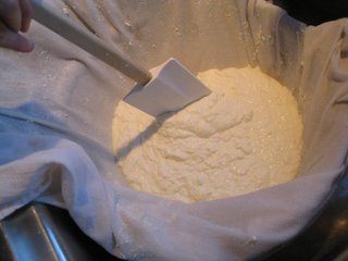Joanne's homemade ricotta cheese draining in cheesecloth.