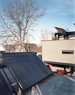 An array of solar thermal tubes crowns the garage, and photovoltaic panels extend like wings over the third-floor deck. "If we were going to make a big architectural move, we had to have reasons," Moore explains, referring to the conspicuous placement of the panels.