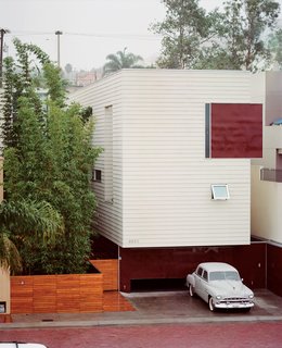 The Becerril family embraces stark modernism with a mute facade clad in Hardie board and acrylic panels. Access to the heart of the house is through the bamboo garden.