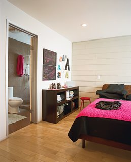 The bedroom in the guesthouse features cheery colors.