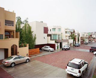 Unlike its neighbors, Casa Becerril is set back from the street and fits a yard onto its tight site.