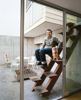 The architect Jorge Gracia sits on his handiwork, an unusual custom-made Cor-Ten stair leading from the courtyard to the guesthouse.