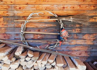 The couple stockpiles wood under the deck.