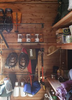 The building that shelters their bathroom also contains a large pantry and storage closet, filled to the brim with camping and outdoor gear.