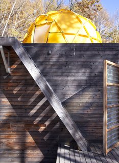 The yellow North Face tent looms over the top of the main building.
