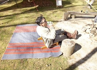 Setsumasa Kobayashi reclines on a striped wool blanket from his 2010 'Horse Blanket Research' line.