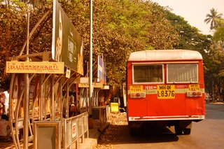 Red buses speed by in every direction. Surely they're painted red so one knows to get out of their way as they barrel toward you!