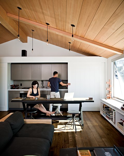 After meals are made, the sliding doors hide the anodized aluminum Miele fixtures, creating a clean, uncluttered look.