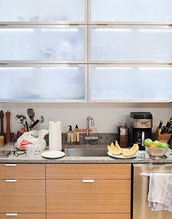 Frosted Tip<br><br>Church wanted open shelving above the kitchen counters, but DeSalvo convinced her to go with Ikea cabinets with frosted-glass doors to ensure a uniform look. He installed inexpensive strip LED lights by Zilotek on the top inside edge of the cabinets to provide ambient illumination and silhouette the contents inside.