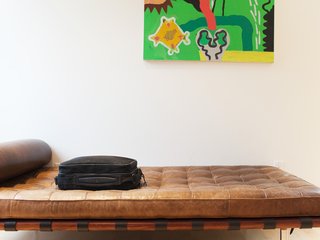 In addition to a desk that doubles as a game table, the front upstairs loft houses a weathered leather Corbusier daybed.