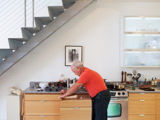 Jett rolls dough on a butcher block-topped storage unit that slides under the countertop to save space.