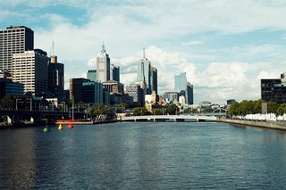 Looking east from the Kings Way Bridge over the Yarra you can see the yellow tower of Flinders Street Station and the points of St. Paul's Cathedral beyond.