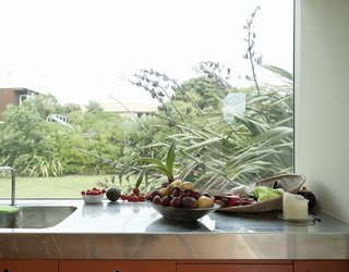 Bach to the Beach - Photo 19 of 30 - Stainless steel countertops are easy to clean and weightless-looking, helping bounce light around the kitchen.