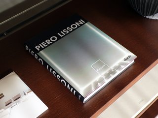 10 Minutes With Piero Lissoni - Photo 2 of 7 - A book of Lissoni’s designs from daab rests on a shelf in his System NXT.
