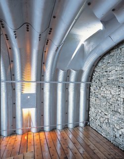 Being inside the boathouse, with its deep corrugations, is a unique experience. "You feel like you're in an upside-down boat or in a whale's body," Adam says. "It's quite beautiful."