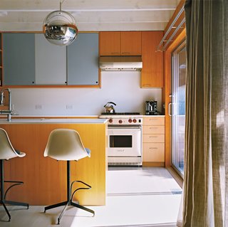A Mirror Ball pendant by Tom Dixon hovers over the kitchen counter.