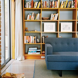 In the living room, a warm woodsy palette reigns, with a few blue-gray notes to create a serene mood.