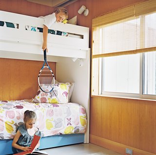 Henry and Emily share a bedroom and a bunkbed made by Ducduc, an American furniture company. Thanks to panel doors that slide into the walls, the bedrooms balance privacy with openness to the rest of the house. With a guestroom and trundle beds in the kids’ rooms, the 1,357-square-foot house can easily sleep four adults and five children—more if people crash on the couches.