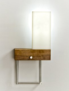 The Cubo lamp by Cerno features a lamp that swivels out from the base for more focused light (such as when reading) and tucks behind a shade for ambient lighting.