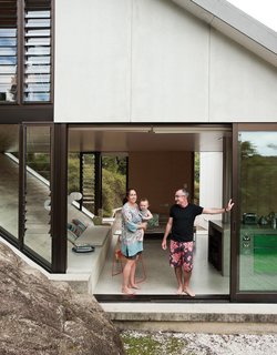 The house Amanda Yates (with her partner, Adam Rose, and their baby, Awa) designed for her parents, David and Christine, occupies a hillside site with views over Maramaratotara Bay.
