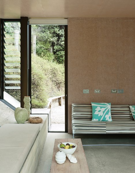 Make Your Parents Happy by Building Them a House - Photo 10 of 25 - In the living area, the wooden bench is part of a set Amanda designed for a 1995 play. The Miss M sofa is by New Zealand designer Simon James.