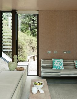 In the living area, the wooden bench is part of a set Amanda designed for a 1995 play. The Miss M sofa is by New Zealand designer Simon James.