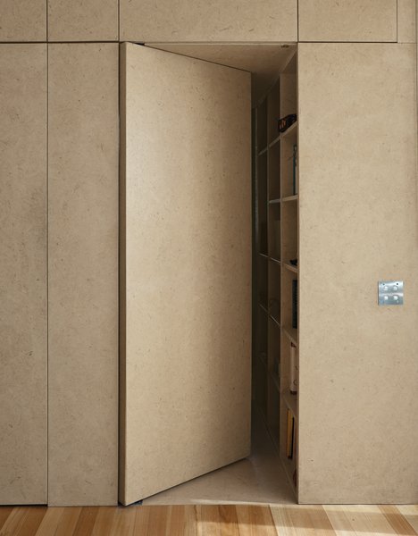 Make Your Parents Happy by Building Them a House - Photo 11 of 25 - An almost-concealed door designed as a part of the kitchen cabinetry leads to the main bedroom and en-suite bath.