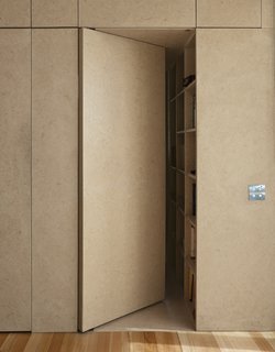 An almost-concealed door designed as a part of the kitchen cabinetry leads to the main bedroom and en-suite bath.