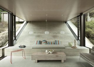 The concrete bench in the living area just past the kitchen is built into the sloping wall. The Pedro wire stool is by Craig Bond for Candywhistle.