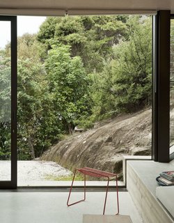 The rock slope just outside is in clear sympathy with the concrete cant inside—nature right alongside architecture.
