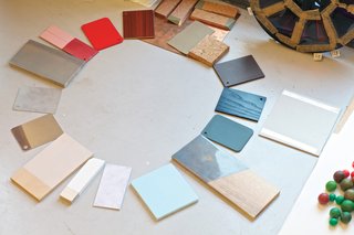 A chromatic composition in progress includes an array of cards from the color system she devised for Vitra, ceramic samples, and other more obscure items.