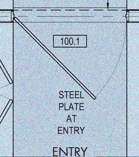 The entrance to the residence requires you to pass through a six-foot-wide steel door. The steel of the ramp seamlessly continues into the residence and ends at the vertical steel art wall.