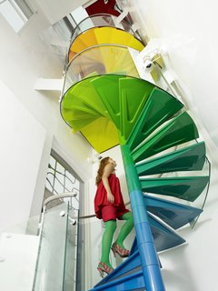 "The staircase is the hub, the soul of the project," Rogers says. "It’s meant to be enjoyed." From the ground, the steps start with the cool colors of the earth, then get warmer as they reach up to the sky.