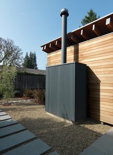 Family Matters - Photo 15 of 16 - Outside, the back of the fireplace functions as a minimalist sculpture.