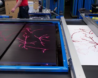 Each color is printed through its own color-specific, stencil-like plate.