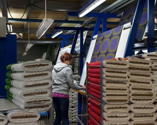 Next, Marimekko’s quality inspectors, some who have worked at the company for more than 30 years, hand-inspect and grade the fabric. Theirs is a meticulous task: There can be only four small errors over 16 yards of fabric.
