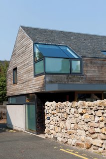 The building's shape and materials are the sort you find in a modernist residence in the UK, but it's the unfussy Japanese interior that reveals a design tailored to this multicultural family.