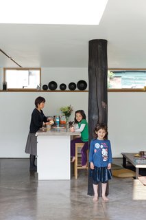 Kiku leans on the "dai koku bashira" as Mika looks on from a barstool from department store John Lewis.