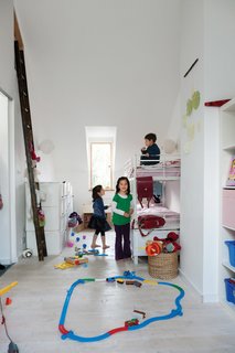 The kids make all the fun they need in their bedroom. Their bunk beds and shelving were bought at Ikea.