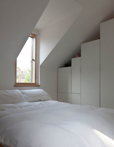 Konishi and Gaffney's bedroom is fairly austere, though a pair of dormers let in lovely natural light.