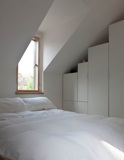 Konishi and Gaffney's bedroom is fairly austere, though a pair of dormers let in lovely natural light.