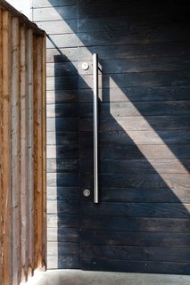 A beloved Japanese tradition is to char exterior cladding to make it fire resistant. Here, the effect on the front door is likely more aesthetic than preventative—though you can never be too careful.